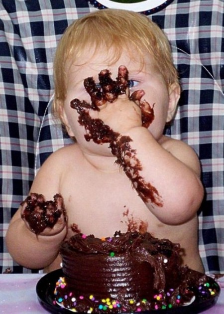 Niño manchandose con el pastel de chocolate